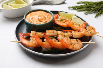 Photo of Skewers with delicious grilled shrimps served on white table