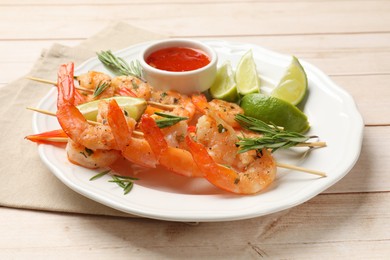 Photo of Skewers with delicious grilled shrimps served on wooden table