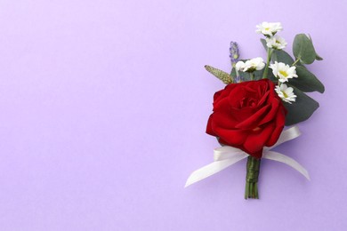 Photo of Small stylish boutonniere on violet background, top view. Space for text