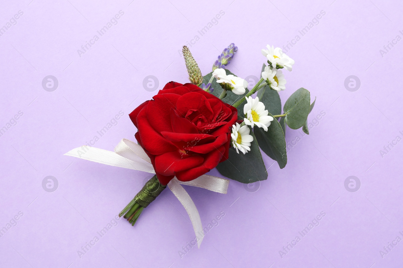 Photo of One small stylish boutonniere on violet background