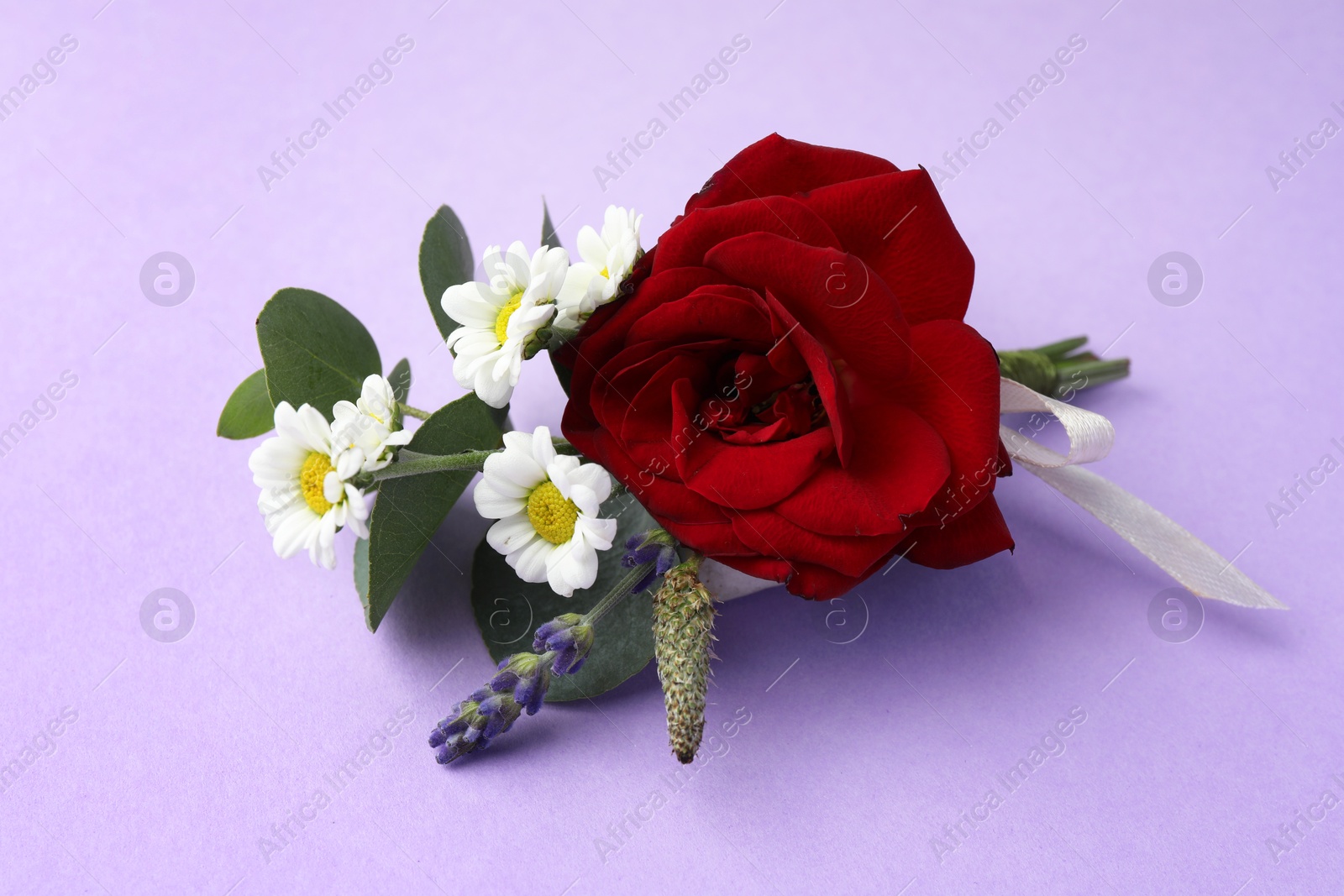 Photo of One small stylish boutonniere on violet background