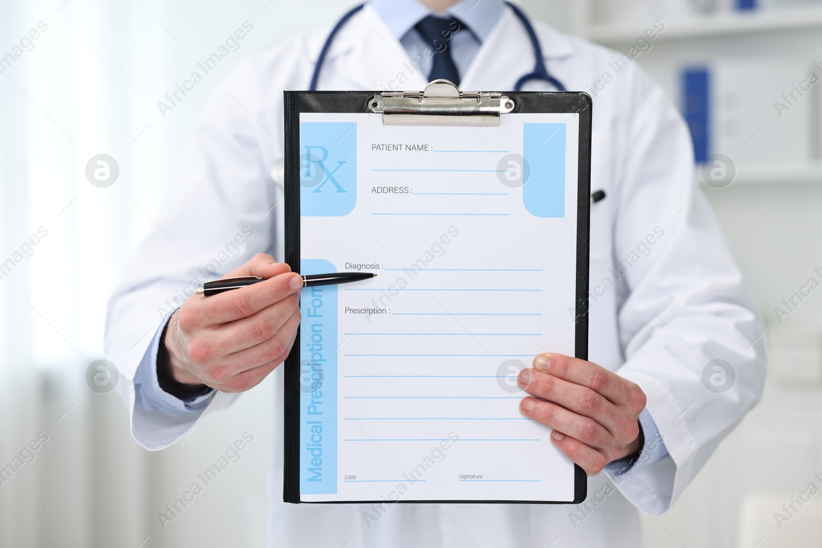 Photo of Doctor with blank prescription form in clinic, closeup