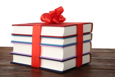 Photo of Stack of books with ribbon as gift on wooden table against white background