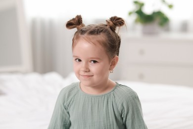 Photo of Portrait of beautiful little girl in bedroom. Cute child