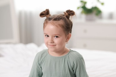 Portrait of beautiful little girl in bedroom. Cute child