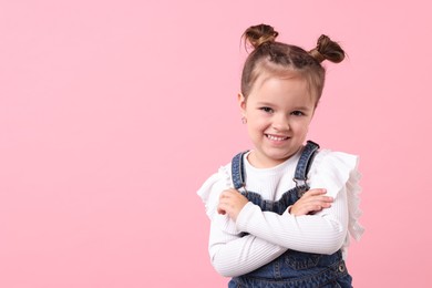 Photo of Portrait of happy little girl on pink background, space for text