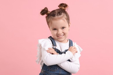 Photo of Portrait of happy little girl on pink background