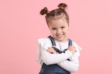 Portrait of happy little girl on pink background