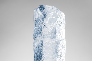 Piece of clear ice on light grey background