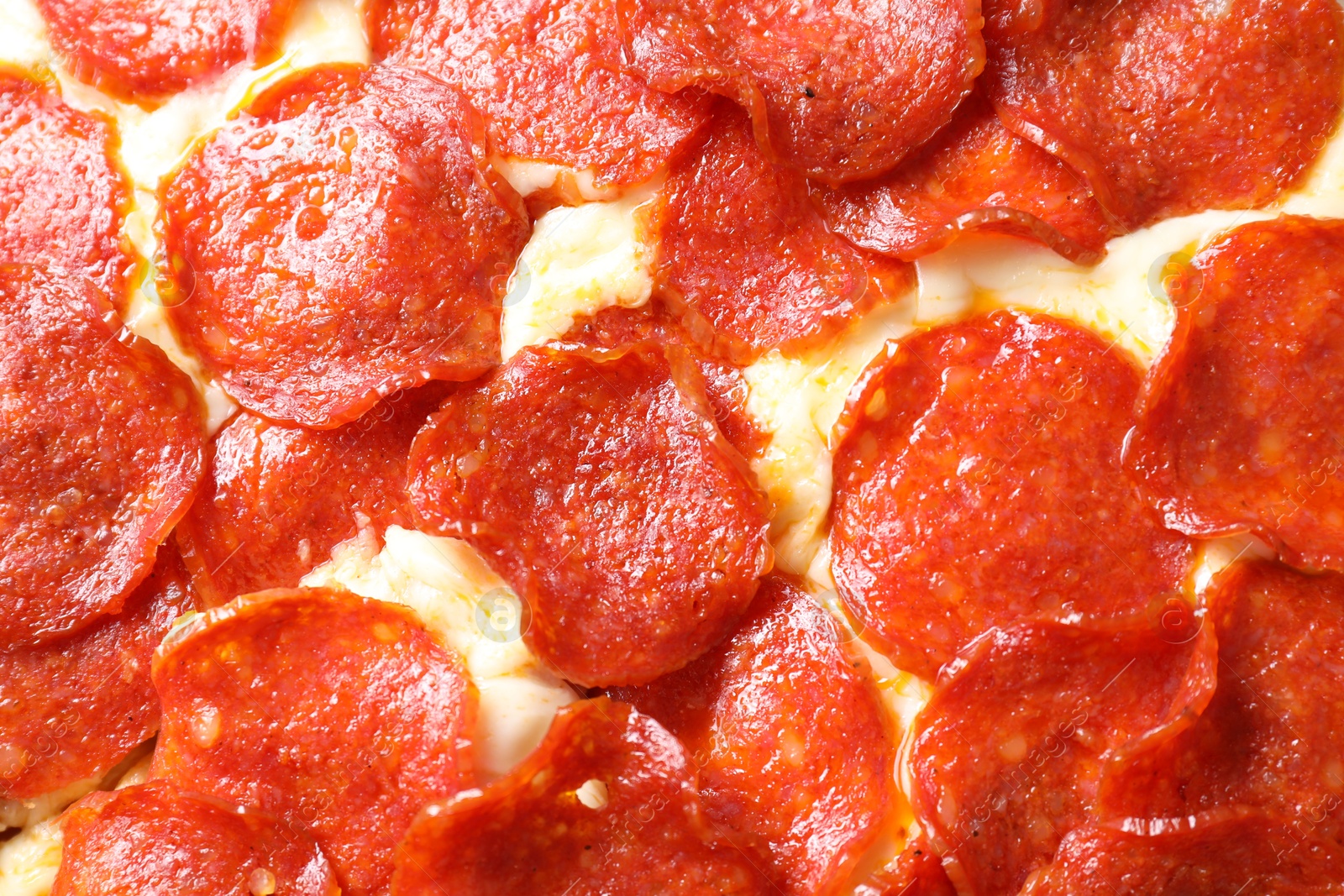 Photo of Tasty pepperoni pizza as background, top view