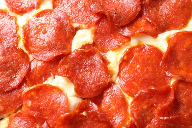 Tasty pepperoni pizza as background, top view