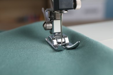 Sewing machine with color fabric indoors, closeup