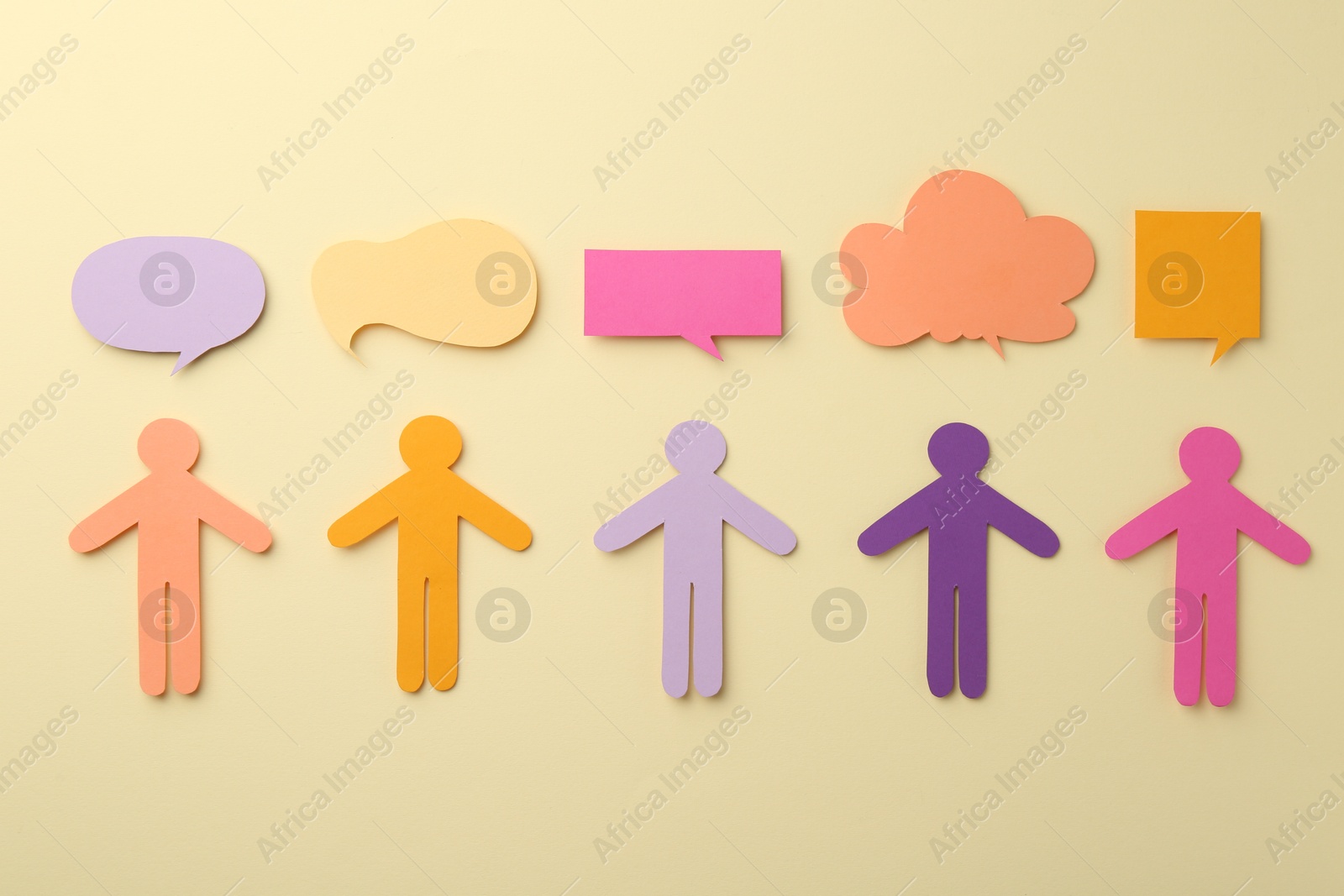 Photo of Equality concept. Paper human figures and different speech bubbles on beige background, flat lay