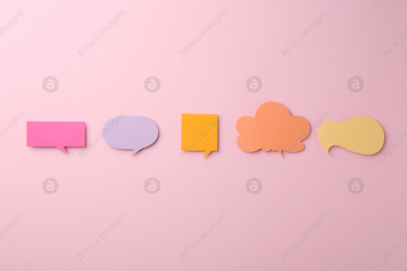 Photo of Equality concept. Different paper speech bubbles on pink background, flat lay