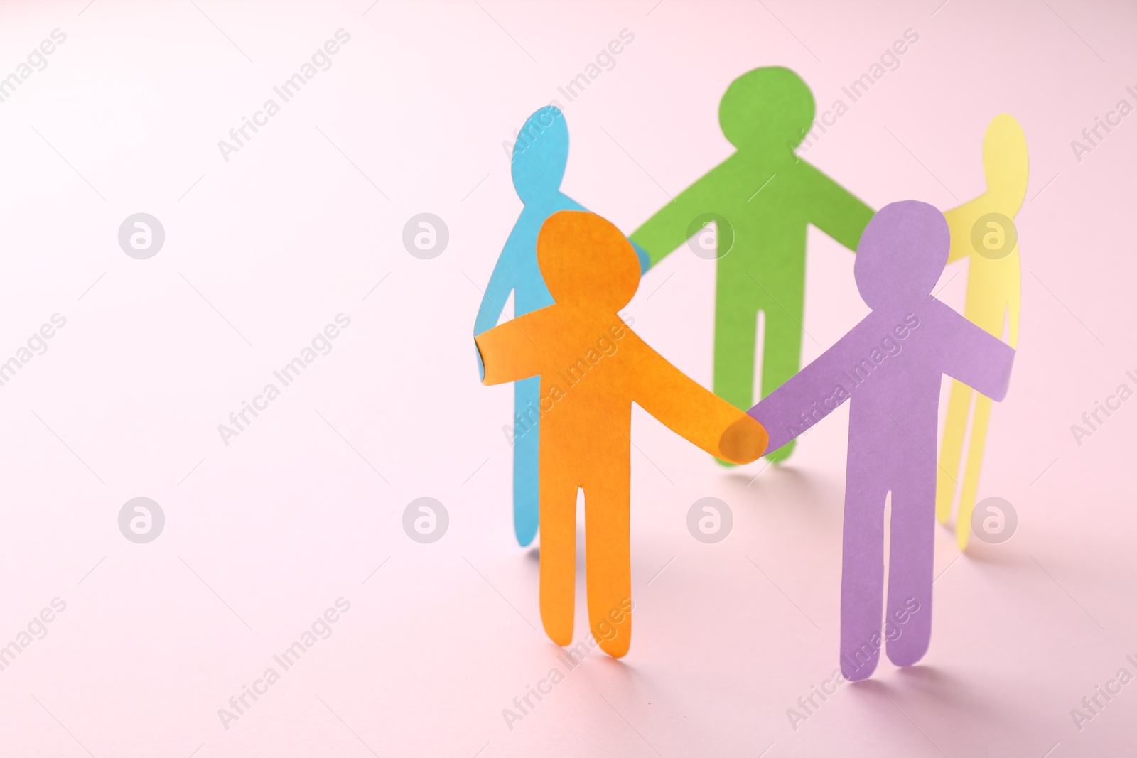 Photo of Equality concept. Paper human figures on pink background, closeup. Space for text