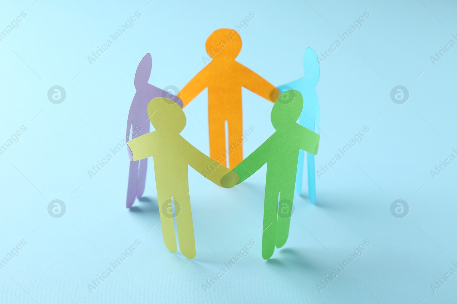 Photo of Equality concept. Paper human figures on light blue background, closeup