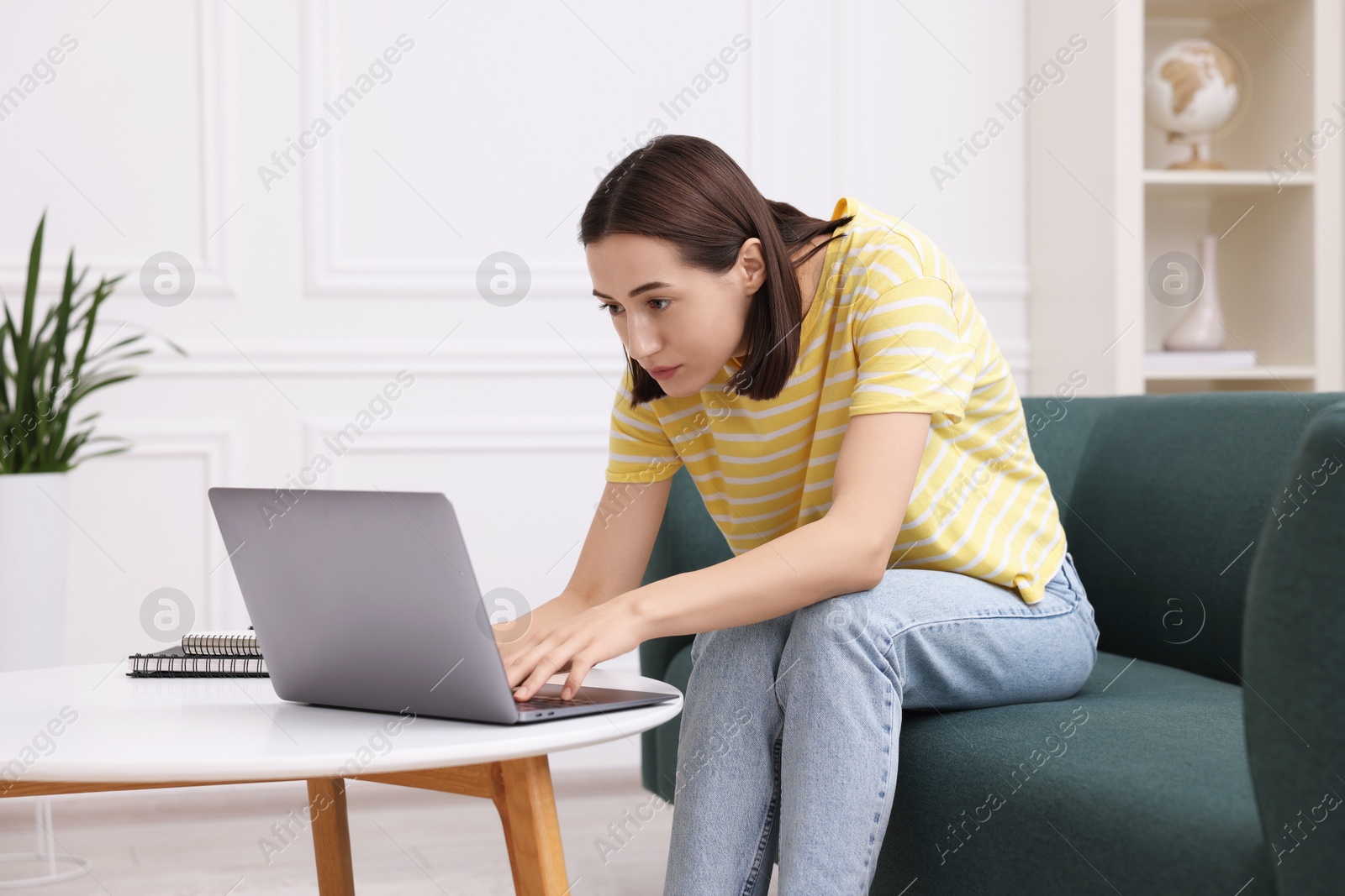 Photo of Woman with poor posture using laptop at home