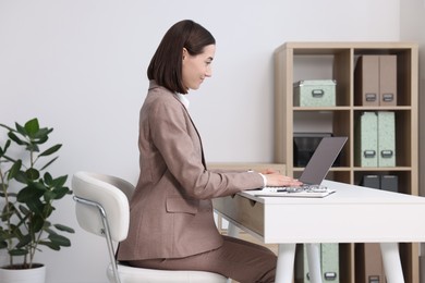 Woman with good posture working in office