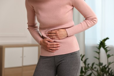 Indigestion problem. Woman suffering from stomachache, closeup