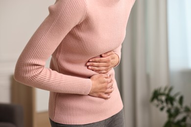 Photo of Indigestion problem. Woman suffering from stomachache, closeup