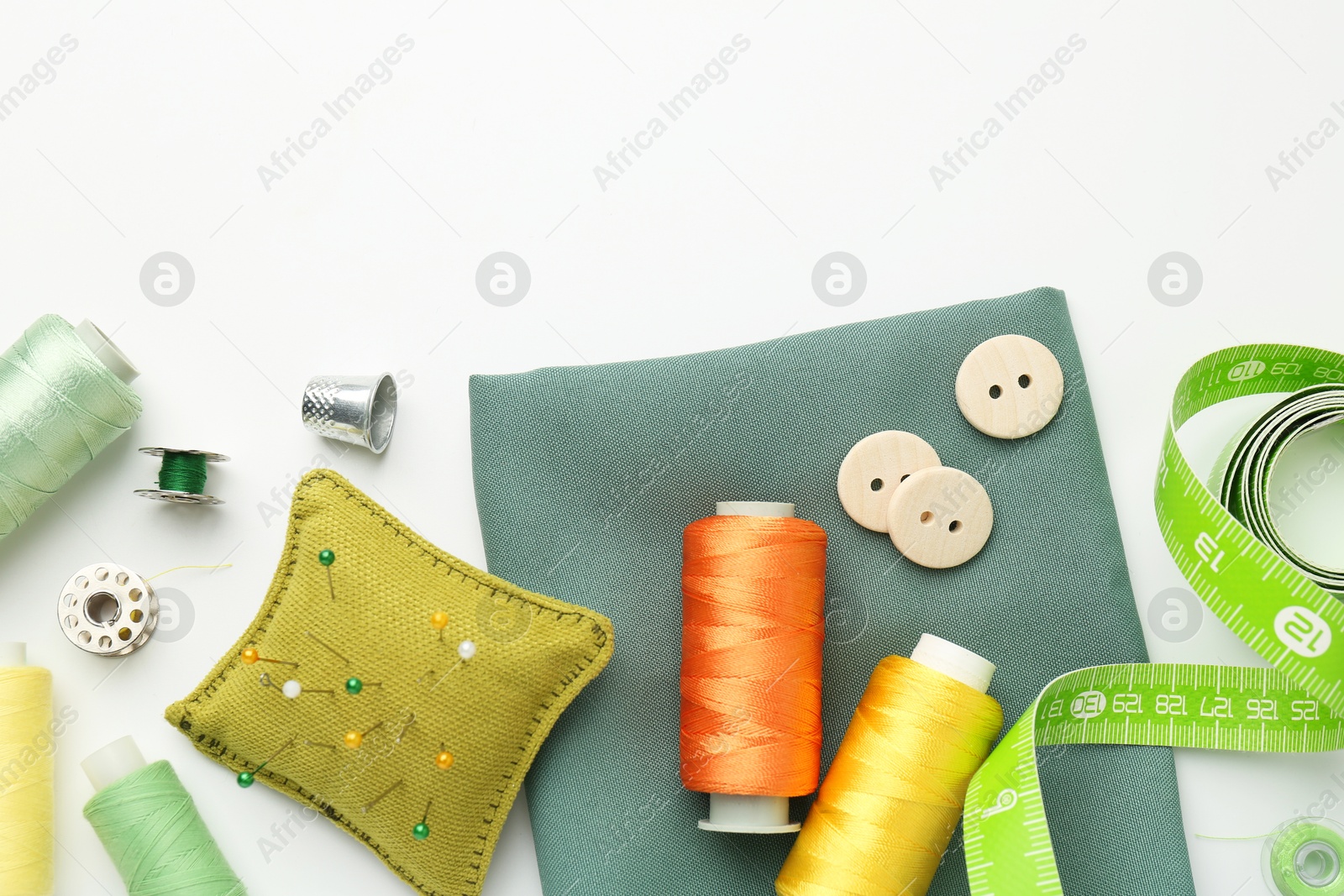 Photo of Flat lay composition with different sewing supplies on white background