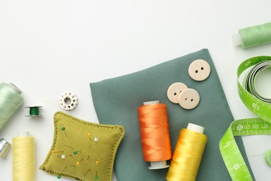 Photo of Flat lay composition with different sewing supplies on white background