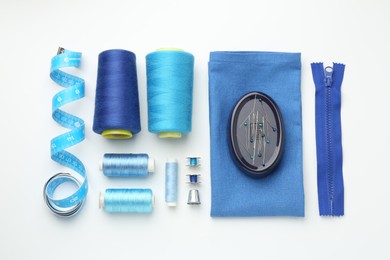 Photo of Flat lay composition with different sewing supplies on white background