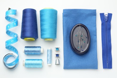 Photo of Flat lay composition with different sewing supplies on white background