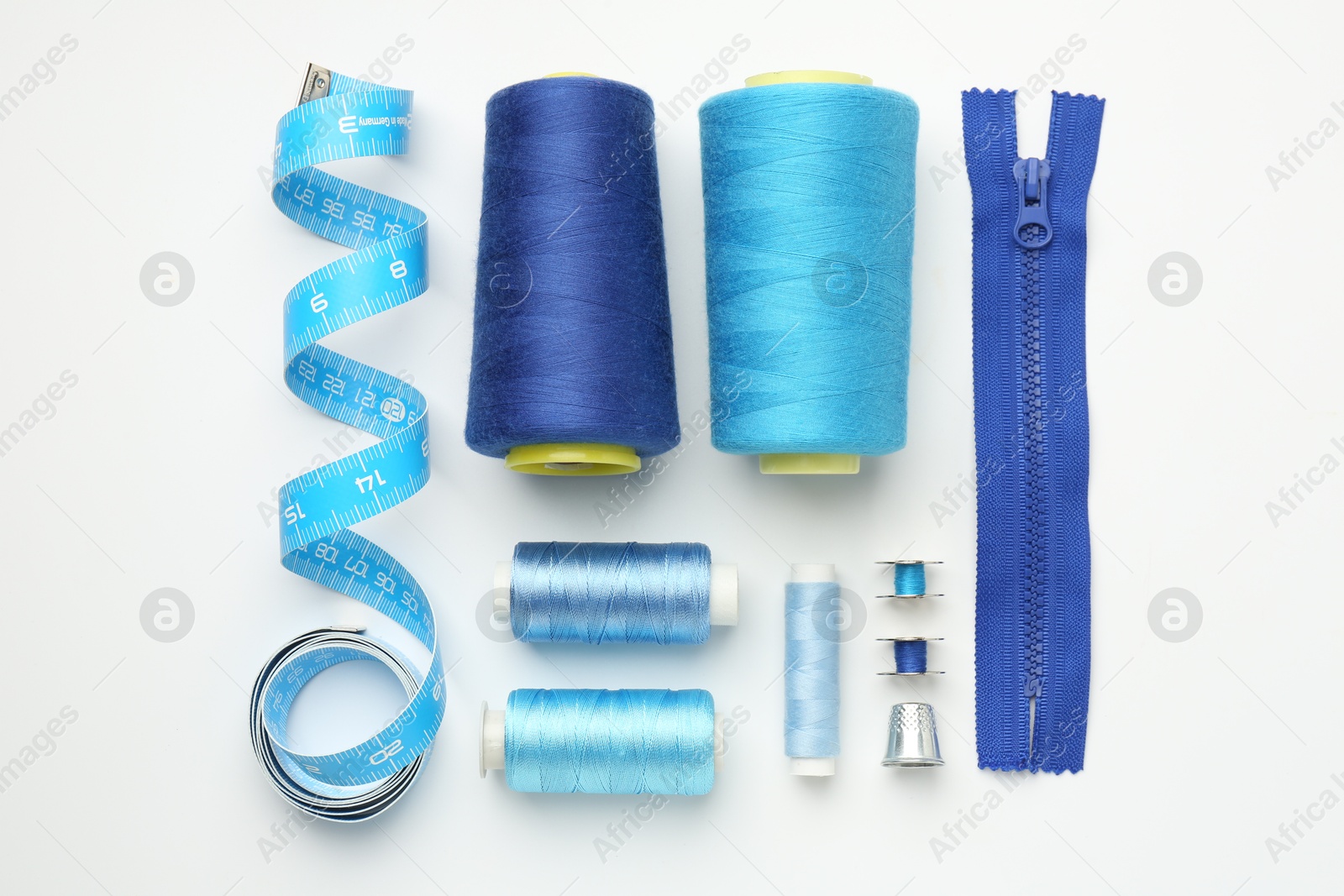 Photo of Flat lay composition with different sewing supplies on white background