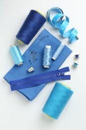 Photo of Flat lay composition with different sewing supplies on white background