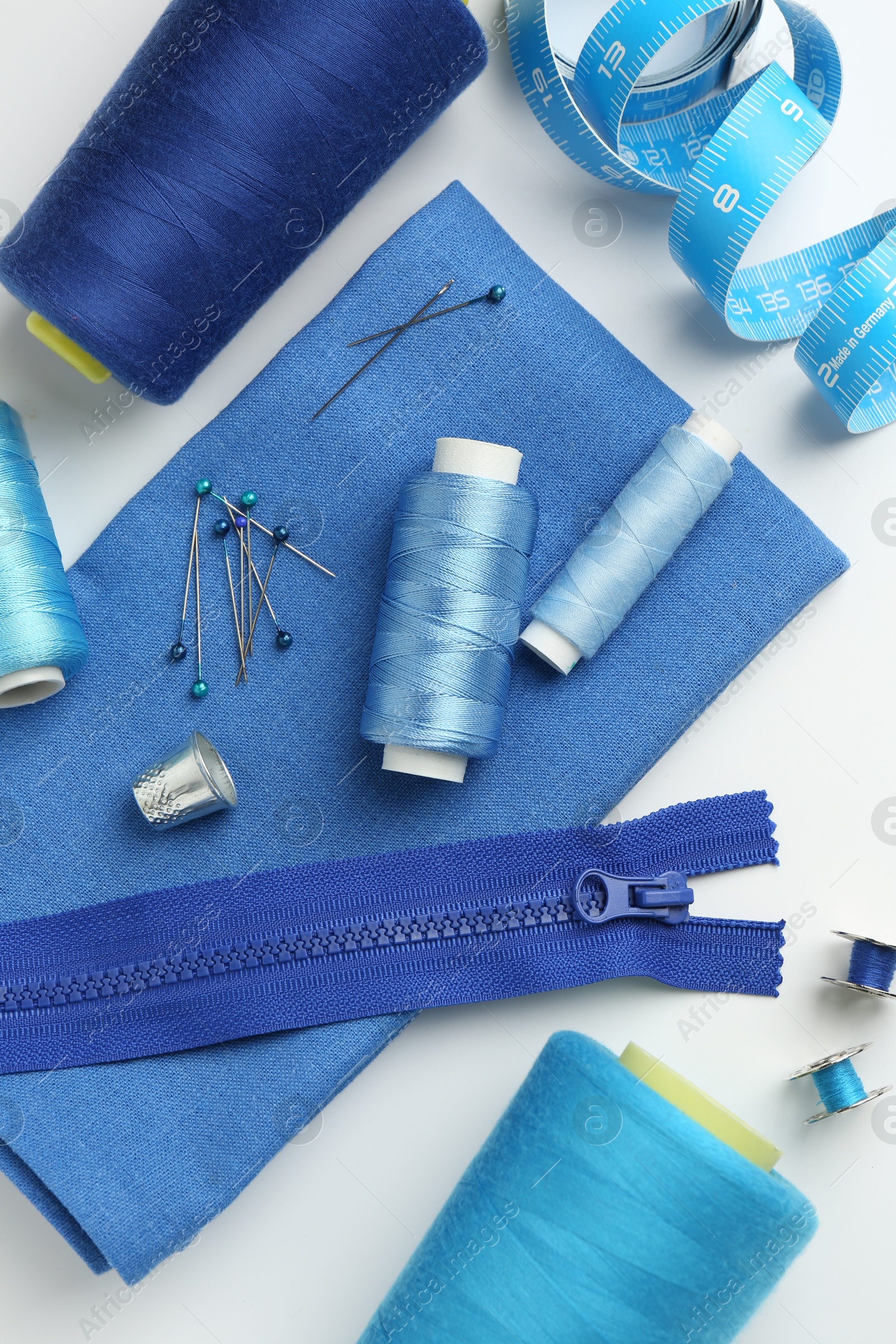 Photo of Flat lay composition with different sewing supplies on white background