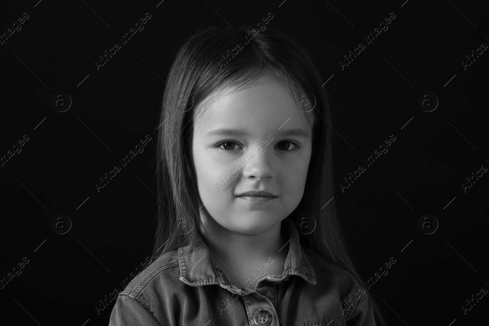 Photo of Portrait of sad girl on dark background, closeup. Black and white effect