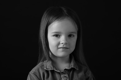 Portrait of sad girl on dark background, closeup. Black and white effect