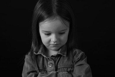 Photo of Portrait of sad girl on dark background, closeup. Black and white effect