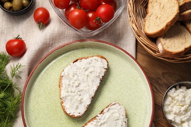 Photo of Delicious ricotta bruschettas and products on wooden table, flat lay