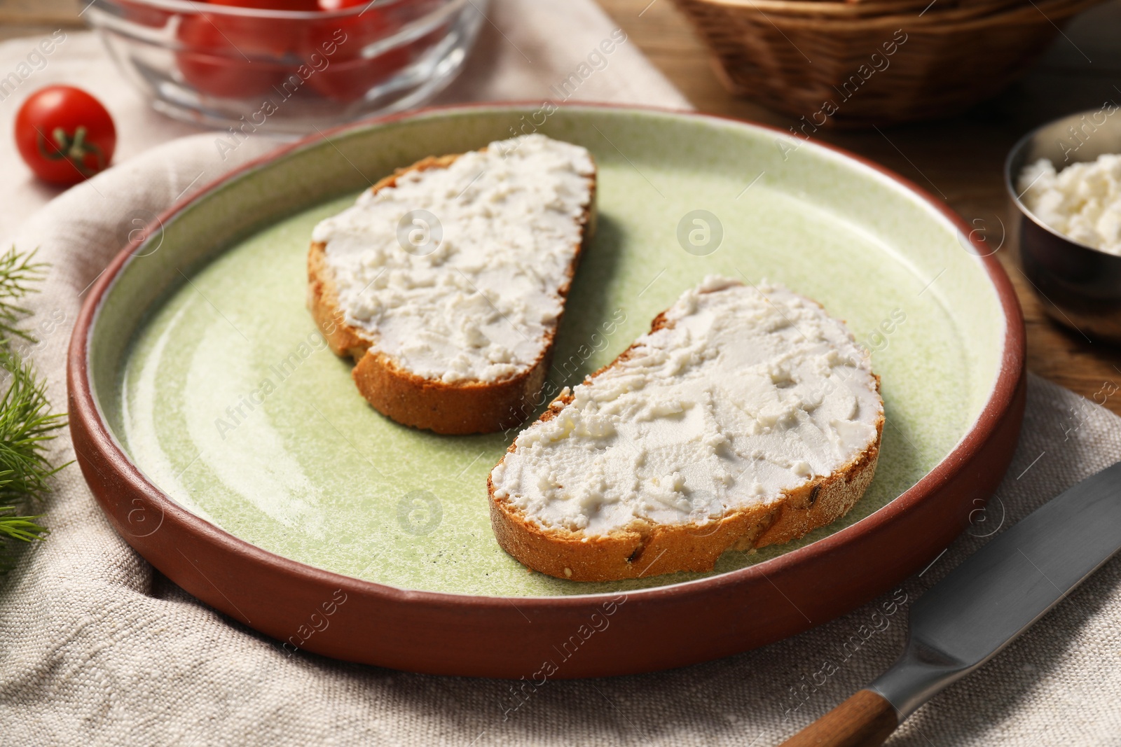 Photo of Delicious ricotta bruschettas and products on wooden table