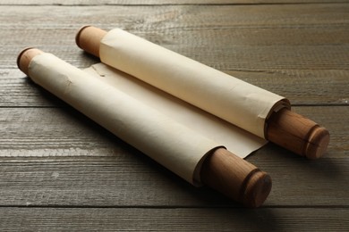 Sheet of old parchment paper with handles on wooden table