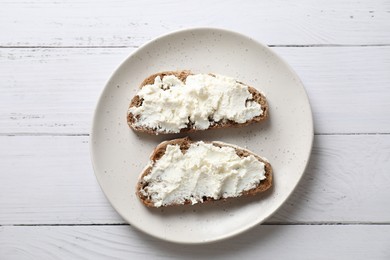 Photo of Bruschettas with ricotta cheese on white wooden table, top view