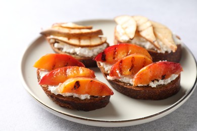 Photo of Delicious bruschettas with ricotta cheese on light grey table, closeup