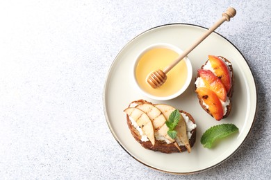 Photo of Delicious bruschettas with ricotta cheese and honey on light grey table, top view. Space for text