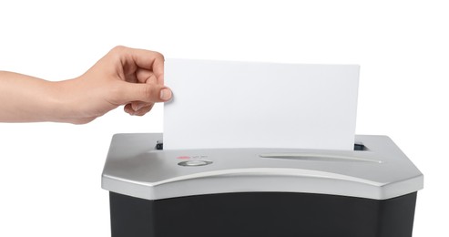 Woman destroying paper with shredder on white background, closeup