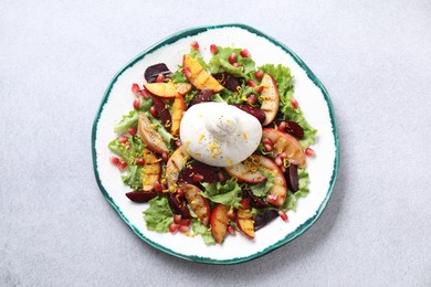 Photo of Plate with fresh burrata salad on grey textured table, top view