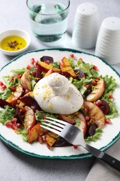 Photo of Plate with fresh burrata salad on grey textured table, closeup