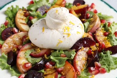 Fresh burrata salad with spices on plate, closeup