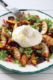 Photo of Plate with fresh burrata salad on white wooden table, closeup