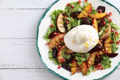 Photo of Plate with fresh burrata salad on white wooden table, top view. Space for text