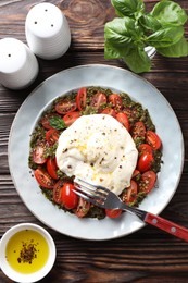 Photo of Fresh delicious burrata salad served on wooden table, top view