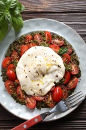 Fresh delicious burrata salad served on wooden table, top view