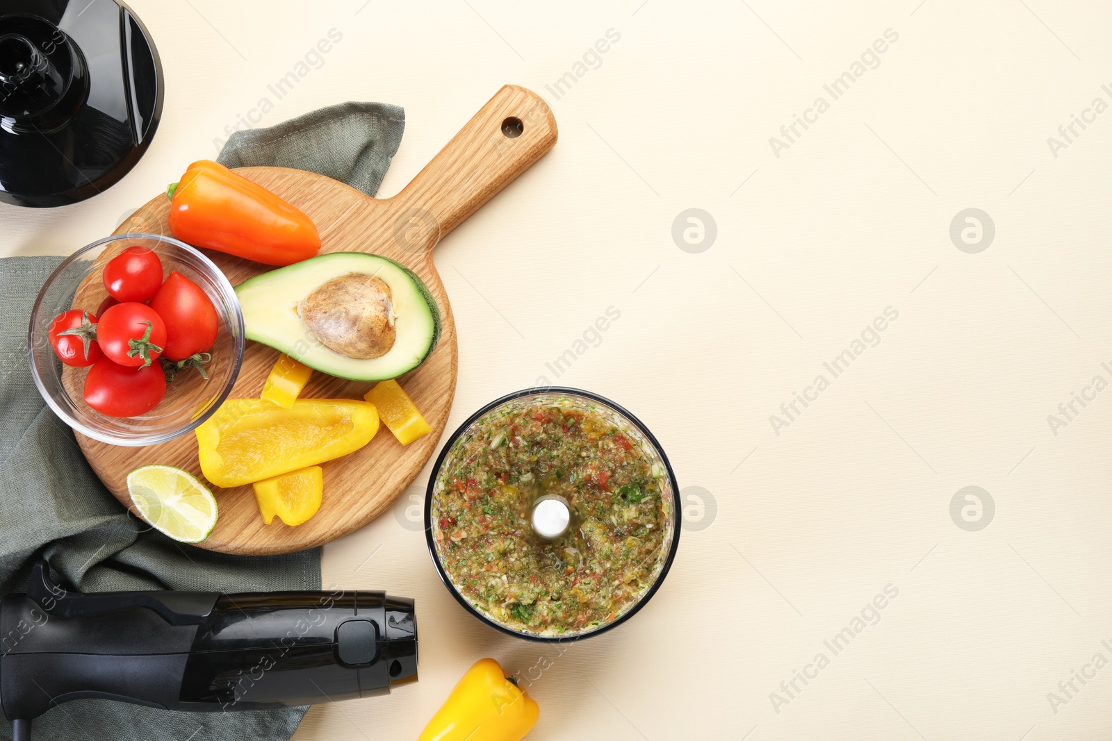 Photo of Hand blender kit, mixture of ingredients and fresh products on beige background, flat lay. Space for text