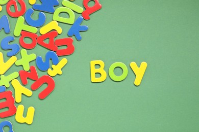 Photo of Word Boy made of magnetic letters on green background, flat lay. Learning alphabet